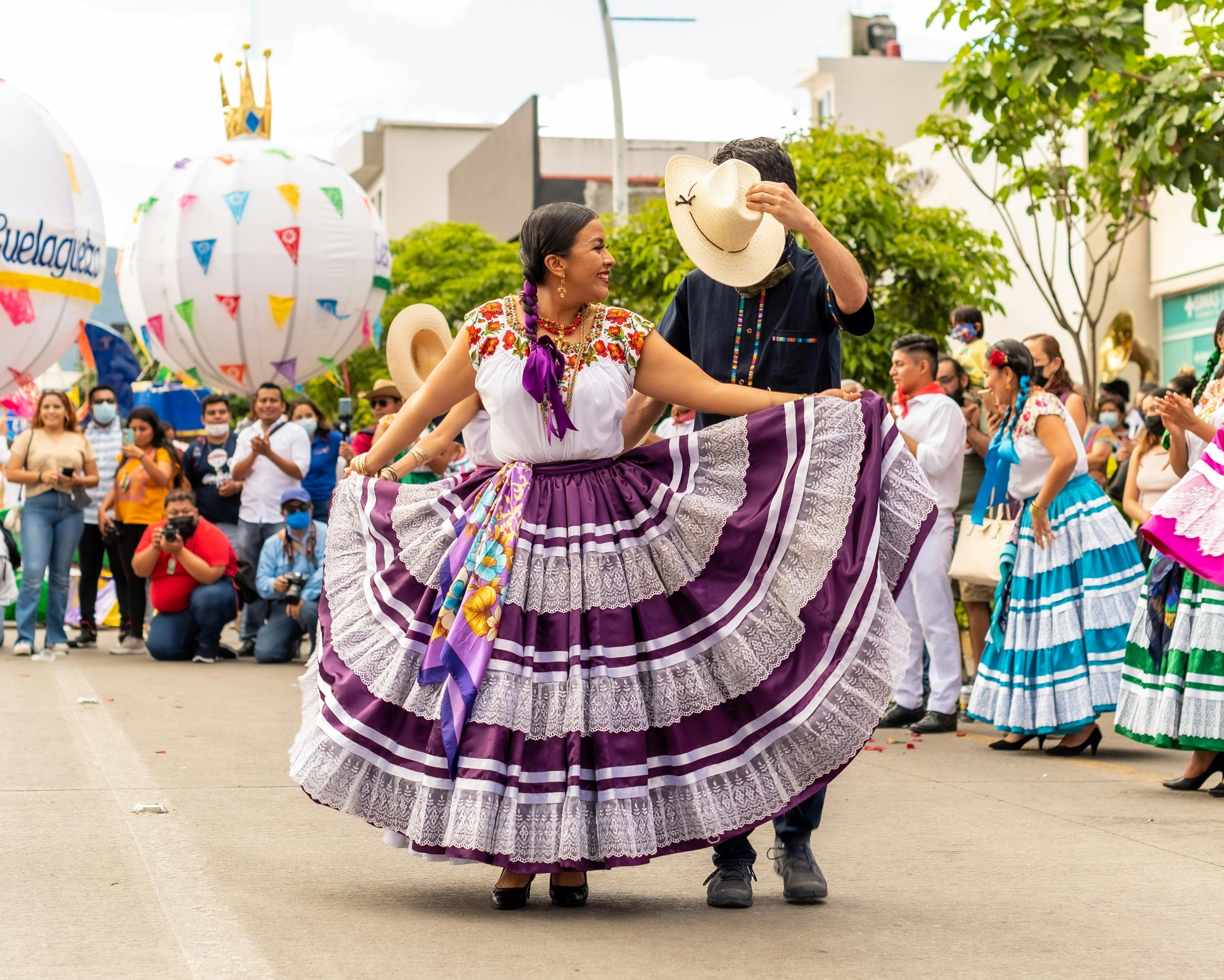 Traditional Mexican dancers performing in colorful dresses at a cultural festival in Oaxaca