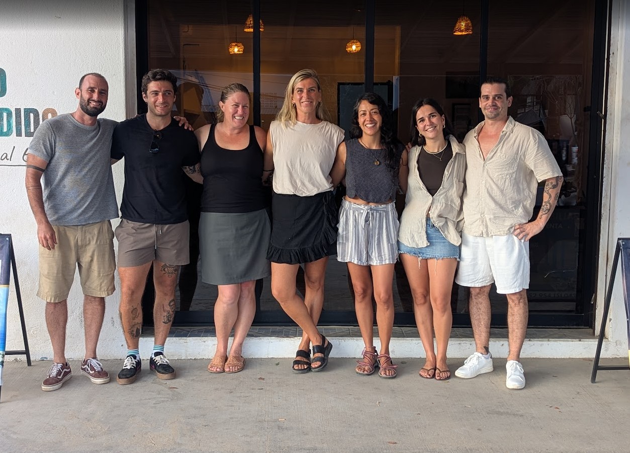 Professional real estate team standing together at their office entrance